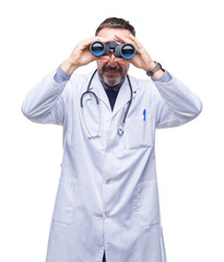 Middle age senior hoary doctor man looking through binoculars isolated background with a confident...