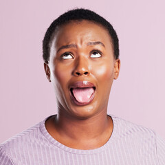 Black woman, face and tongue out in studio with funny for comic meme, silly comedy and eye roll. African girl, pink background and crazy emoji with mouth for weird expression and wild or goofy person