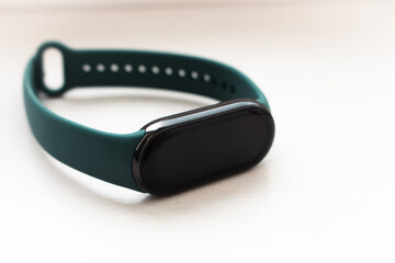 Fitness tracker with mockup screen and green strap on white background. Sport wristband with...