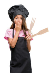 Brunette hispanic girl wearing cook uniform cover mouth with hand shocked with shame for mistake,...
