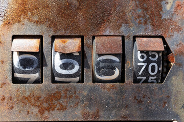 Old rusty gas pump numbers.. Old rusty gas pump detail. Close-up of an old rusty pump  in a french street. 