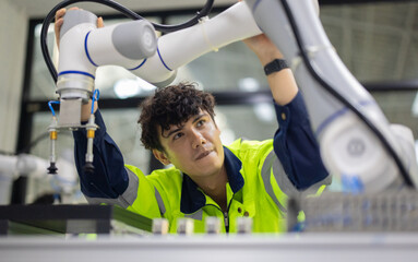 Trainees master robotics with hands-on workshops and quality control in manufacturing academy.