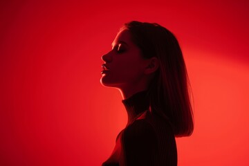 Silhouette of a woman in red light, side profile, artistic portrait photography ideal for themes of drama, mystery, and modern aesthetics.

