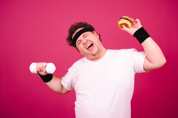 Sports nutrition and healthy lifestyle. Funny fat man and his bad habits. Pink background. 
