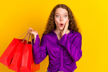 Photo portrait of pretty young girl amazed hold shopping bags wear trendy violet outfit isolated on...