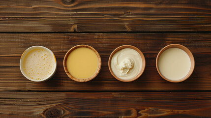 Different milk on wooden background