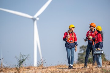 engineer team inspection check control wind power machine construction installation in wind energy factory. technician professional worker discussion check for maintenance electronic wind turbine