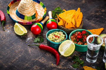 Traditional Mexican food nachos, salsa, guacamole, tequila.