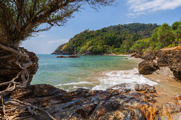 Beautiful view of sea, cliffs and rocks, tree and lush nature at the Mu Ko Lanta National Park in Koh Lanta, Thailand, on a sunny day.
