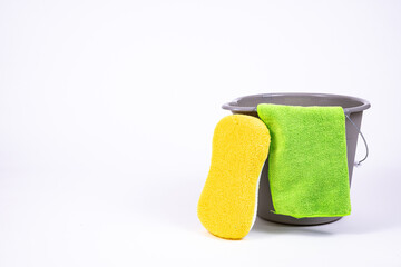 Gray bucket with yellow sponge.