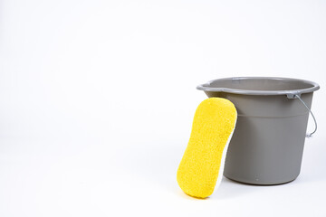 Gray bucket with yellow sponge.
