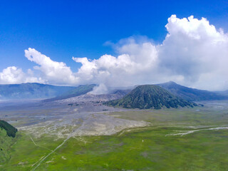 Naklejka premium aerial view of Bromo volcano, East Java, Indonesia with smoke coming out of the crater.