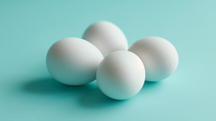Four white eggs on a blue background