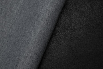 black artificial leather with waves and folds on PVC base