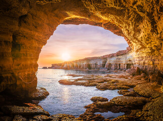 Stunning sunset view of Ayia Napa sea caves in Cyprus, showcasing a serene Mediterranean landscape.