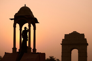 Silhouette of Subhas Chandra Bose statue under canopy behind India Gate war memorial in glorious...