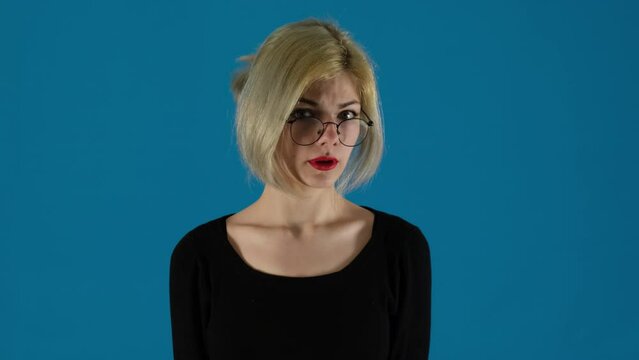 Businesswoman swears waving arms around on blue background. Woman office worker frustration evident in gestures during argument