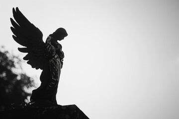 Poignant silhouette of an angel statue set against a solemn, grey sky, evoking a sense of mourning...