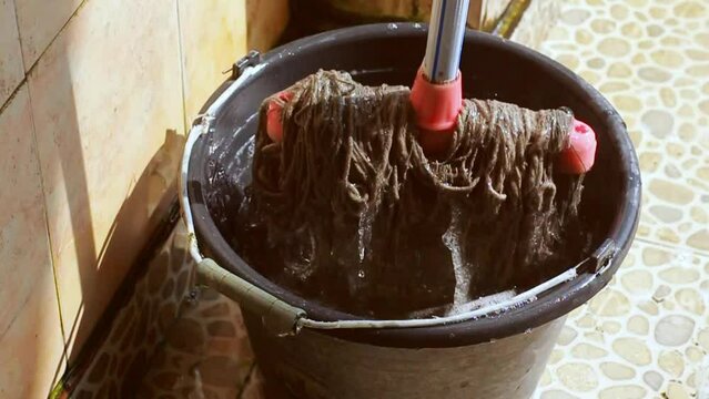 A mop and a bucket of soapy water.