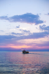 Beautiful sunset over calm sea, with vivid colors and clouds in the sky. Serenity and nature concept