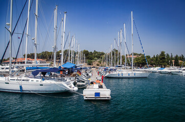 Fototapeta premium Coastal town and marina with boats and clear blue sky. European travel and vacation concept