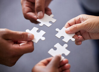 Hands, collaboration and business people with puzzle in office for teamwork or synergy with joint...