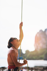 Rock climbing, nature and man with rope for training, exercise and extreme sports on outdoor cliff....
