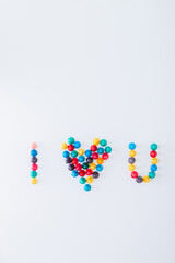 many colored ludo pawns strung together forming the word 