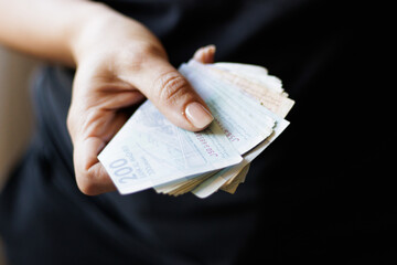 Hand holding Moroccan banknotes, dirham official currency of Morocco.