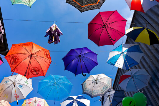 Looking up decoration of colorful hanging umbrellas at terrace of Restaurant named Gerold Chuchi at Swiss City of Z&uuml;rich on a sunny spring noon. Photo taken May 10th, 2024, Zurich, Switzerland.