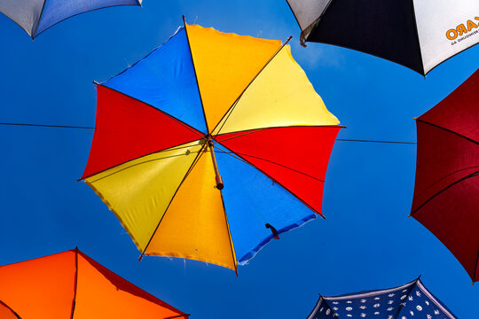 Looking up decoration of colorful hanging umbrellas at terrace of Restaurant named Gerold Chuchi at Swiss City of Z&uuml;rich on a sunny spring noon. Photo taken May 10th, 2024, Zurich, Switzerland.