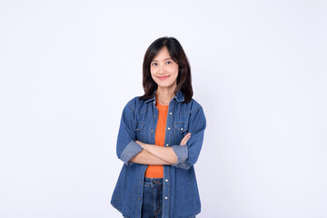 Asian woman is wearing orange t shirt and denim shirt against a white background.
