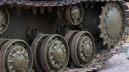 The front of a tank with rusted wheels