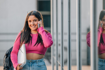 student talking on mobile phone on the street