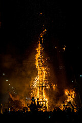 Vertical image of a wooden structure in flames during the celebration of St. John's Eve, June 24,...