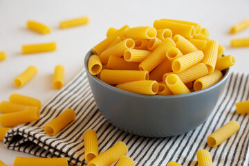 Dry Rigatoni Pasta in a Bowl, side view.
