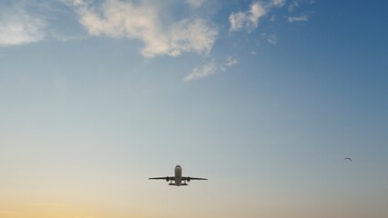 Airplane in the sky at sunset. Air transportation.  Travel. Airplane Takes Off Against the Background of Blue Sky. 