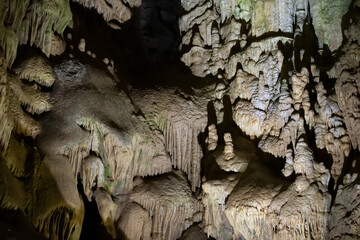 The cave is karst, amazing view of stalactites and stalagnites illuminated by bright light, a...