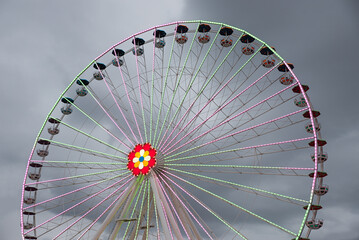 Ferris wheel with colored lights on the Prater in Vienna. dark clouds in the background