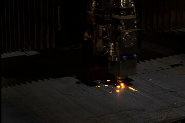 Cutting of metal. Sparks fly from laser.Laser cutting machine working with sheet metal with sparks...