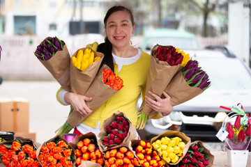 A woman with a bouquet of tulips. A flower seller at the market with bouquets on a pre-holiday day.