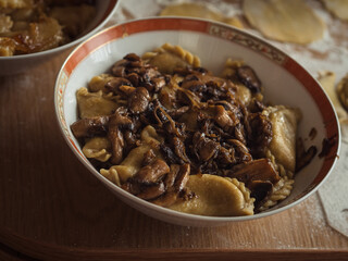 Horizontal close-up of a dish with Ukrainian varenyky, dumplings akin to Italian ravioli, with...