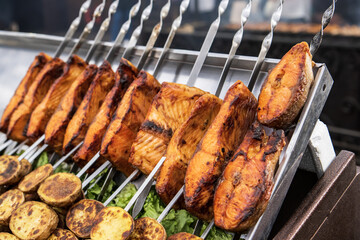 Grilled salmon on metal skewer