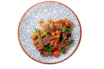 Fragrant roast of offal, lamb or beef meat with tomatoes and onions in a plate, isolated on white....