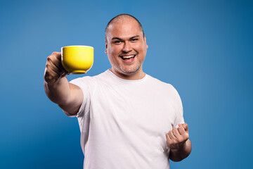 man holding a cup and celebrating