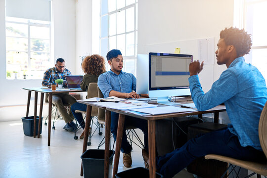 Business people, office and computer with online programming for game design, software or teamwork. Men, desk and entrepreneur company for tech startup with creative, development or collaboration