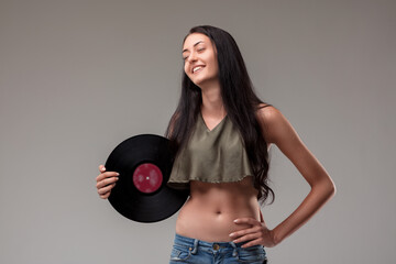 Young, cheerful woman with flat belly displays classic music rec