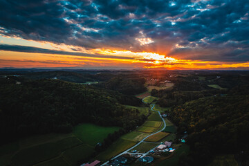 Sunset in Riegersburg, Styria with Vibrant Skies Over Rolling Hills, Aerial View of Peaceful...