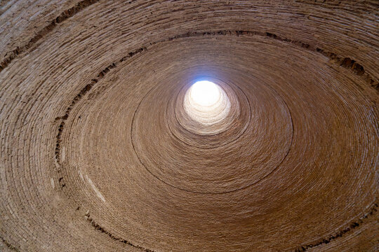 Inside the historic Yakhchal, sunlight streams in through the top opening. This is a testament to ancient Persian cooling technology. Yazd, Iran.