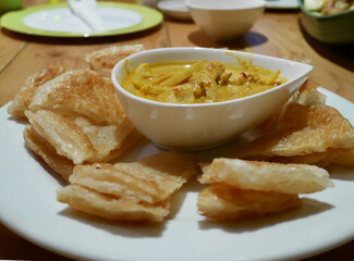 Indian pancake served with chicken curry
